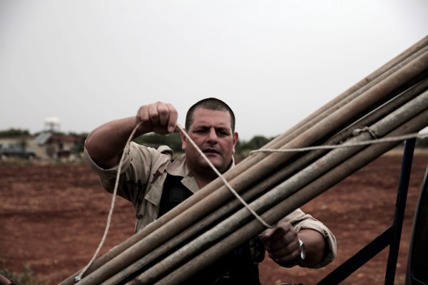 A British army policeman dismantles a trap used by poachers to catch migratory birds on May 6, 2014, on a British sovereign base in the region of Dhekelia, between the southern Cypriot coastal towns of Larnaca and Ayia Napa. Cypriot authorities cracked down hard on illegal hunting in the years running up to the island's accession to the European Union in 2004, with up to an 80 percent decline in the numbers of birds killed. AFP PHOTO / Yiannis Kourtoglou